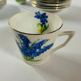 Vintage English bone china cup, saucer, and dessert plate with bluebell floral pattern and gold rim