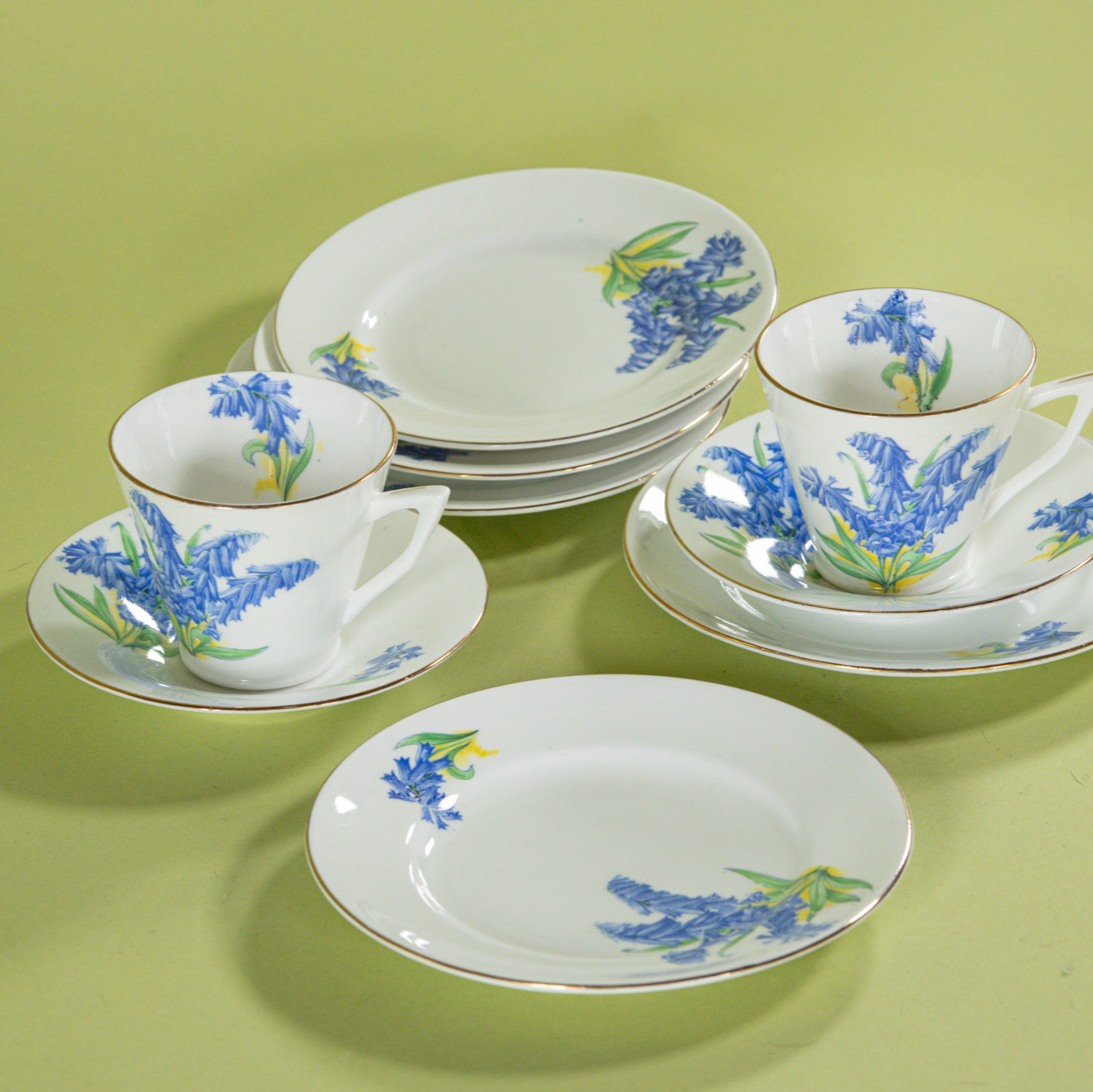 Vintage English bone china dessert set with bluebell floral pattern, cups, saucers, and plates