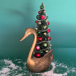 a Vintage Tall Brass Swan w/ Red/Green Christmas Tree Centerpiece against a green background. 