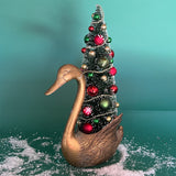 a Vintage Tall Brass Swan w/ Red/Green Christmas Tree Centerpiece against a green background. 