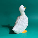 Back of Vintage ceramic duck statuette in white with yellow beak and feet