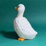 Back of Vintage ceramic duck statuette in white with yellow beak and feet