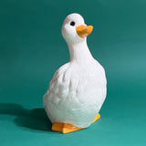 Vintage ceramic duck statuette in white with yellow beak and feet