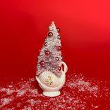 a white floral Vintage Ceramic Swan w/ Flocked Christmas Tree Centerpiece against a red background. 