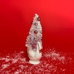 a white floral Vintage Ceramic Swan w/ Flocked Christmas Tree Centerpiece against a red background. 