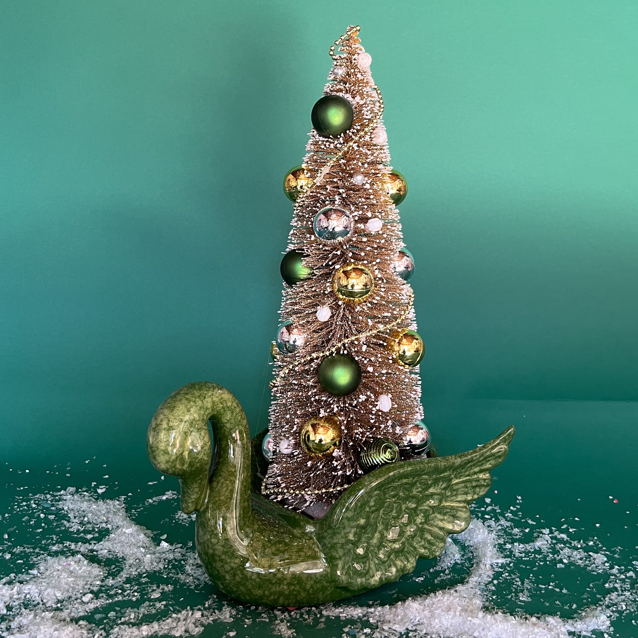a green Vintage Ceramic Swan w/ Gold Christmas Tree Centerpiece against a green background. 