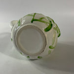 Vintage ceramic pitcher with sculpted leafy design and green hand-painted details