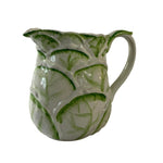 Vintage ceramic pitcher with sculpted leafy design and green hand-painted details
