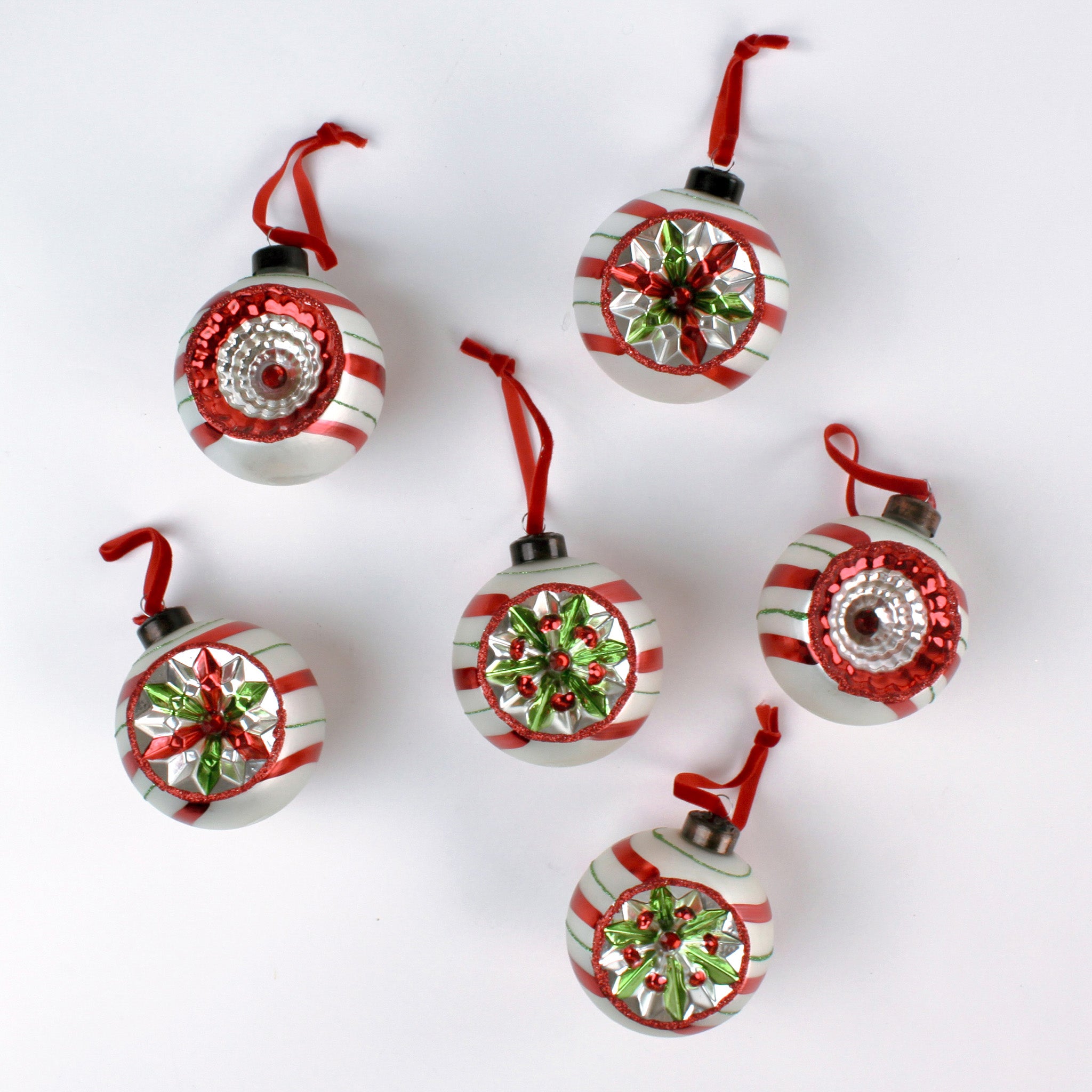 Set of six vintage-style glass Christmas ball ornaments with red, white, and green candy stripe patterns and reflective floral accents