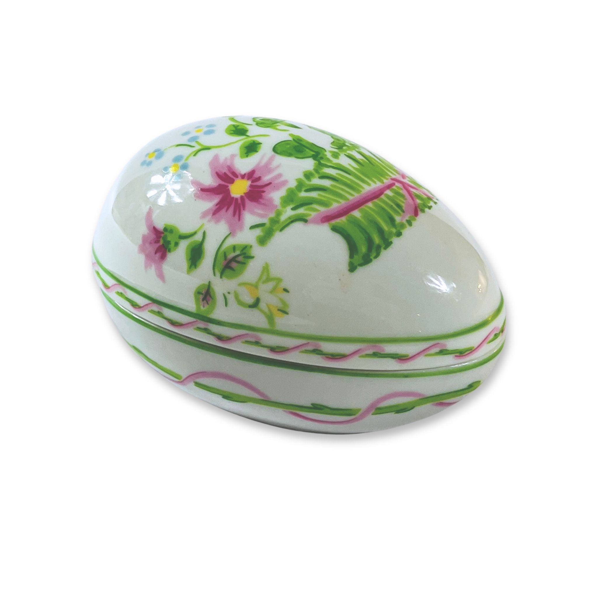 Decorative ceramic egg with floral patterns on a white background