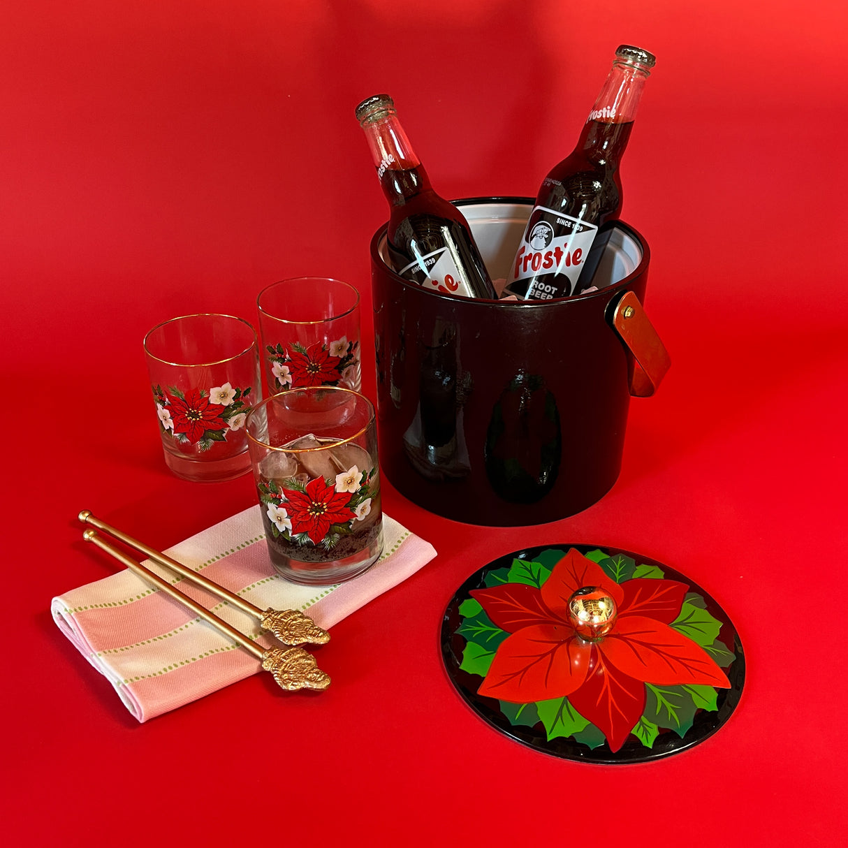 Vintage Christmas ice bucket with poinsettia motif lid and three matching glasses