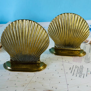 A pair of scallop shaped brass shell bookends. 