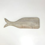 A wood charcuterie board in the shape of a whale