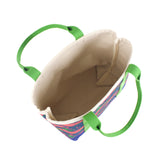 this image shows the inside of a large Whale of a Time canvas tote bags with lime straps and blue fabric with a repeating pink whale  and green star motif.