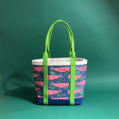 Large Whale of a Time canvas tote bag with lime straps and blue fabric with a repeating pink whale  and green star motif.