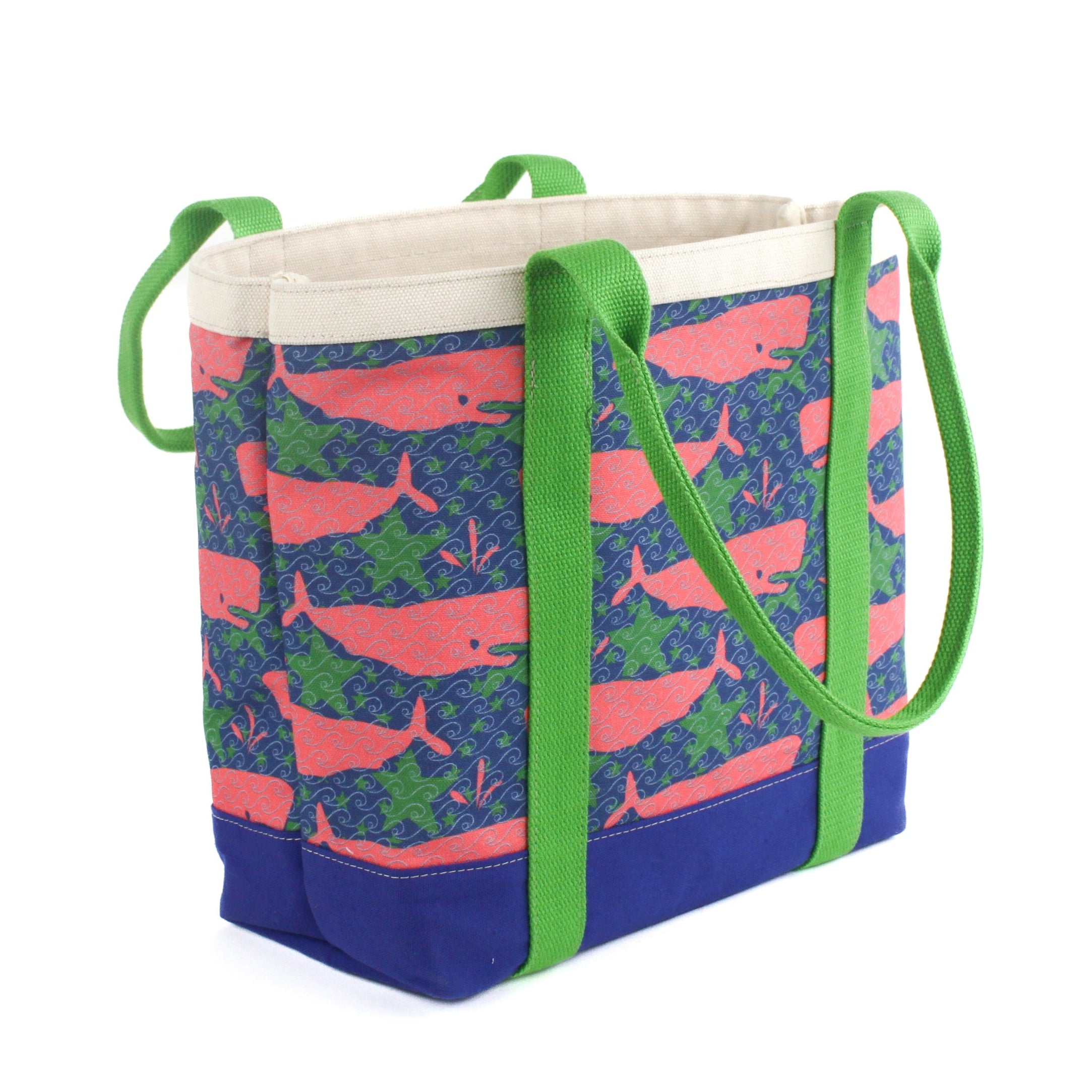 a large Whale of a Time canvas tote bags with lime straps and blue fabric with a repeating pink whale  and green star motif.