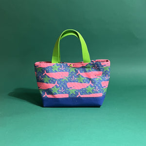 Small Whale of a Time canvas tote bag with lime straps and blue fabric with a repeating pink whale  and green star motif.