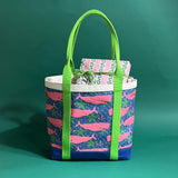 Large Whale of a Time canvas tote bag with lime straps and blue fabric with a repeating pink whale  and green star motif with presents sticking out of the top.