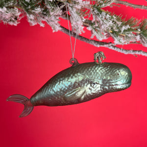 A glass christmas ornament in the shape of a blue whale