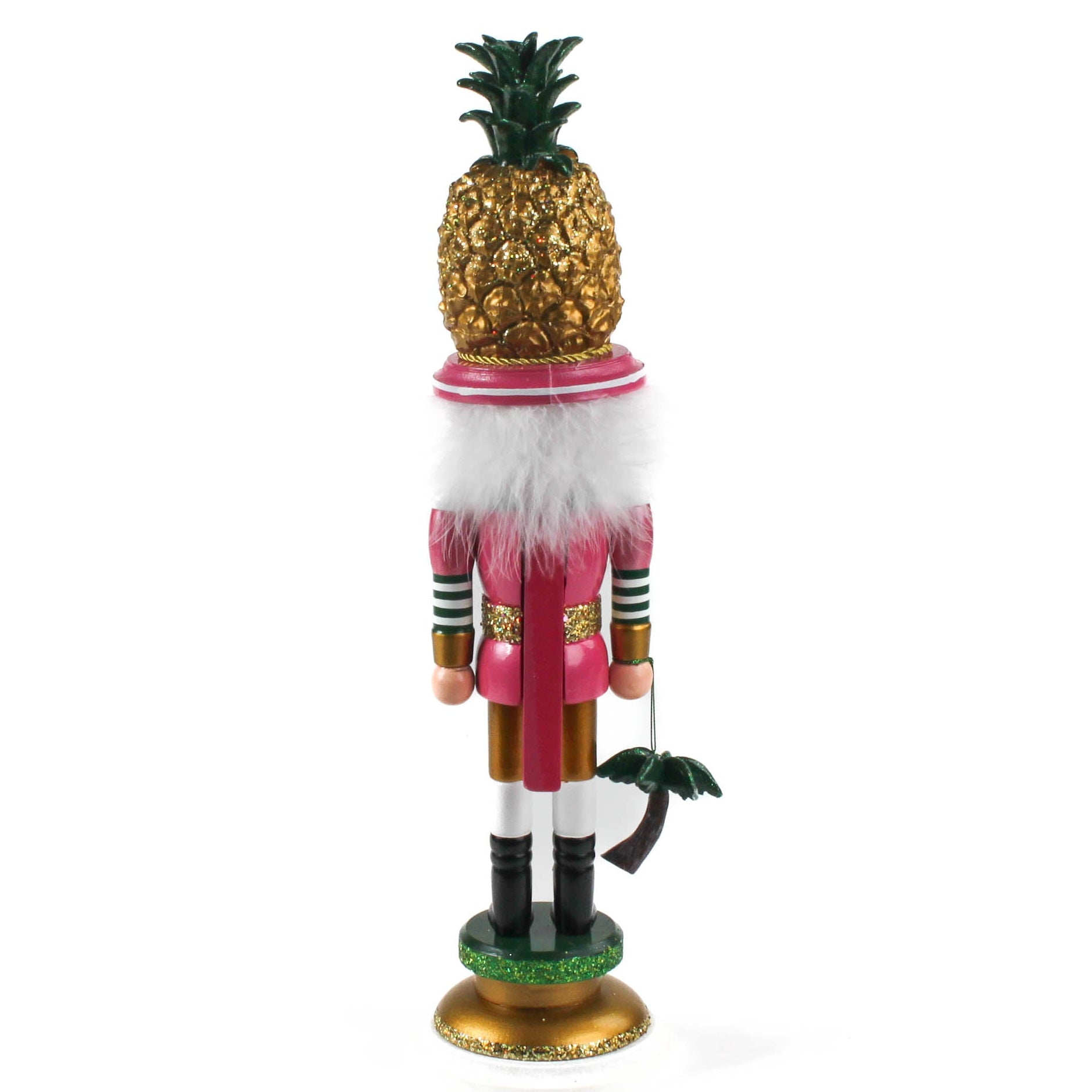  back view of a 19.5" tall Yellow and Pink Christmas Nutcracker Table Decoration with a gold pineapple hat and  holding a palm tree against a white background. 