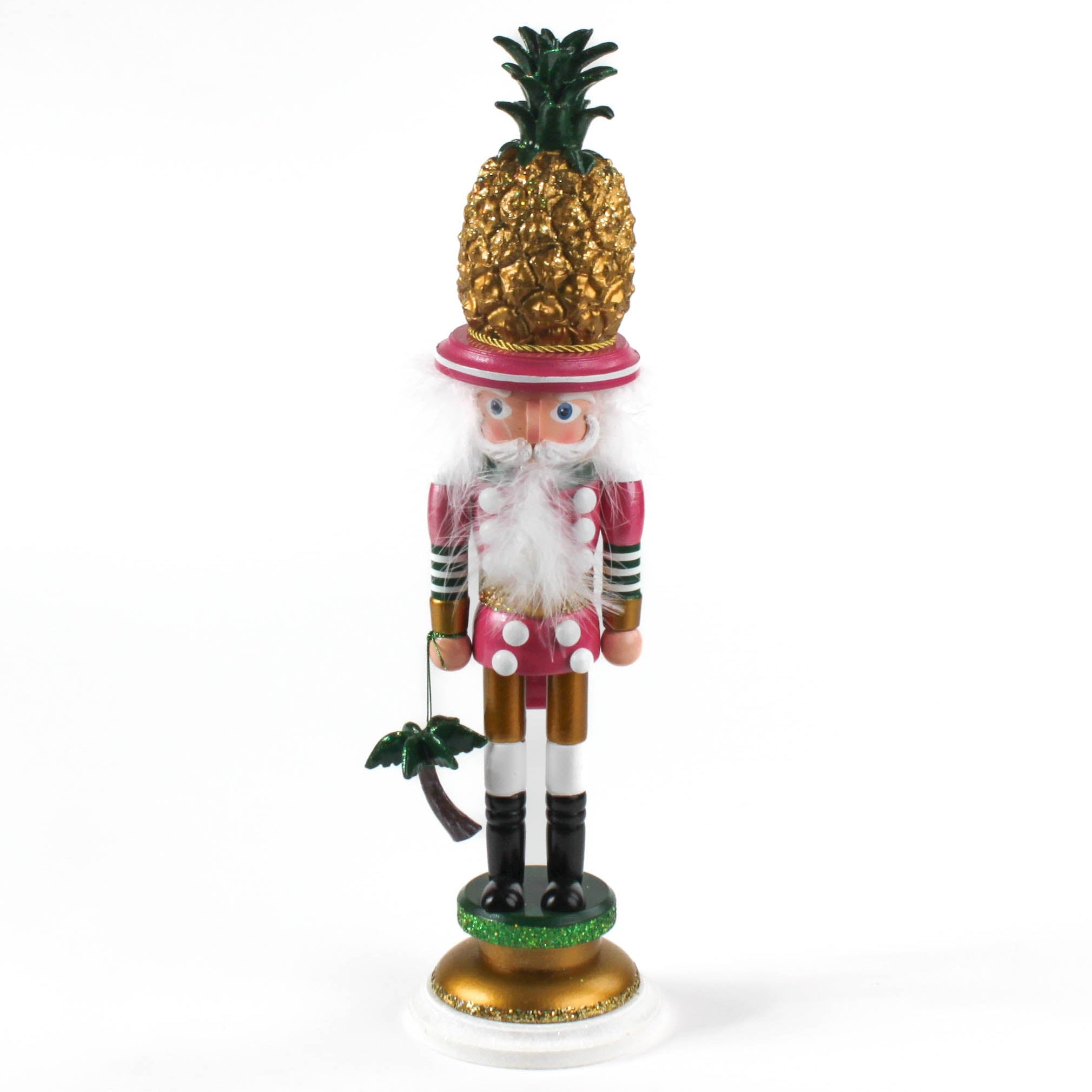 a 19.5" tall Yellow and Pink Christmas Nutcracker Table Decoration with a gold pineapple hat and  holding a palm tree against a white background. 