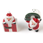 Two ceramic christmas salt and pepper shakers shaped like the letters 'H' and 'O' with Santa Claus figures on a white background.