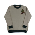 Neutral knit sweater with embroidered acorn and oak leaf motif on the chest
