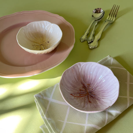 two flower shaped bowls on a table
