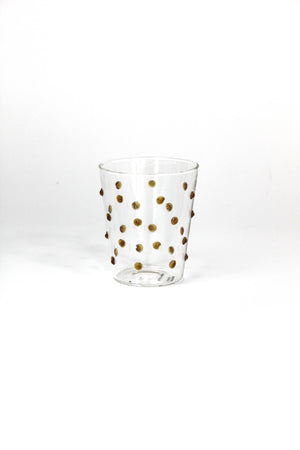Clear glass with gold polka dots on a white background