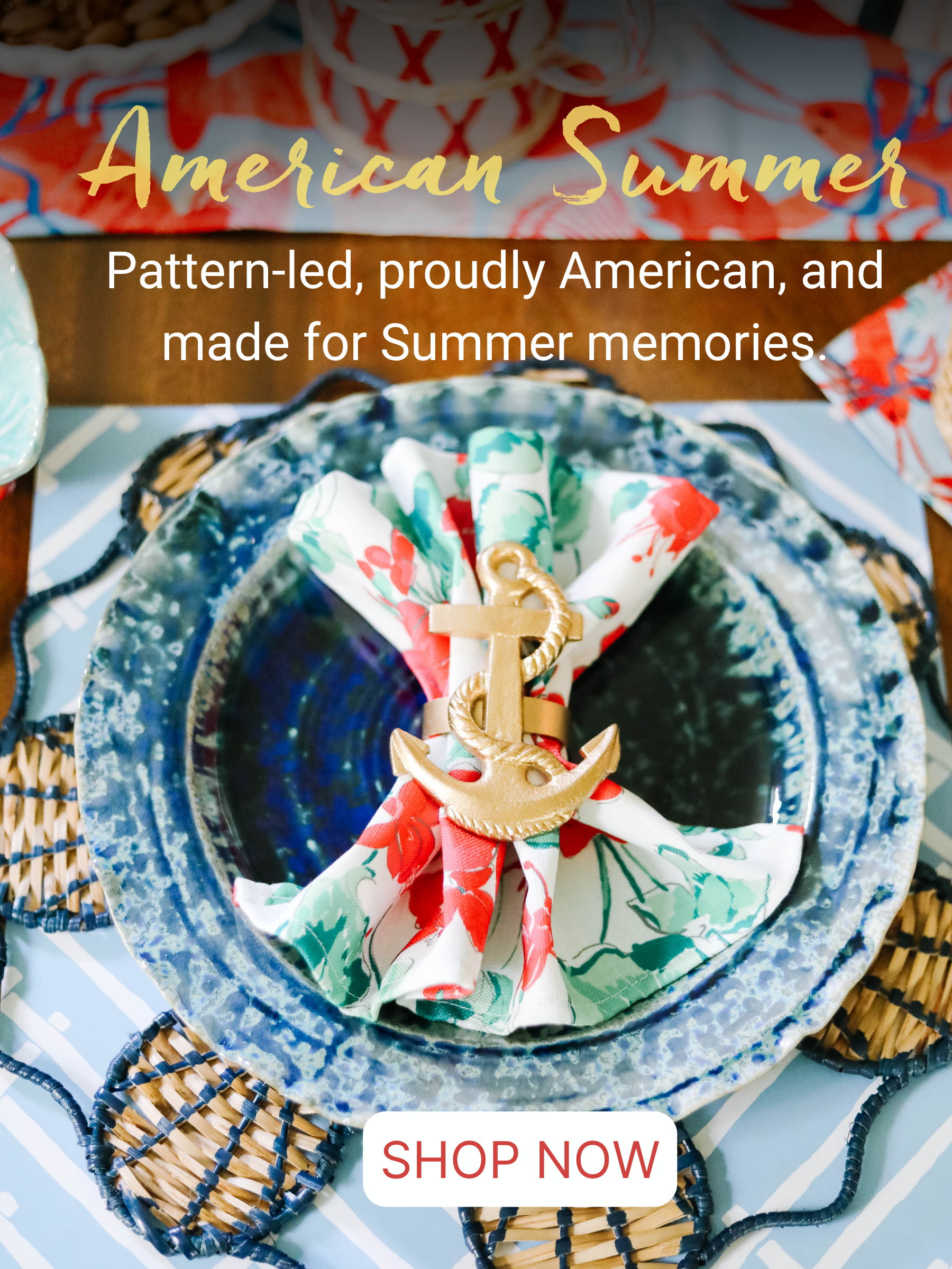 a blue plate topped with a geranium print napkin and gold anchor napkin ring. 