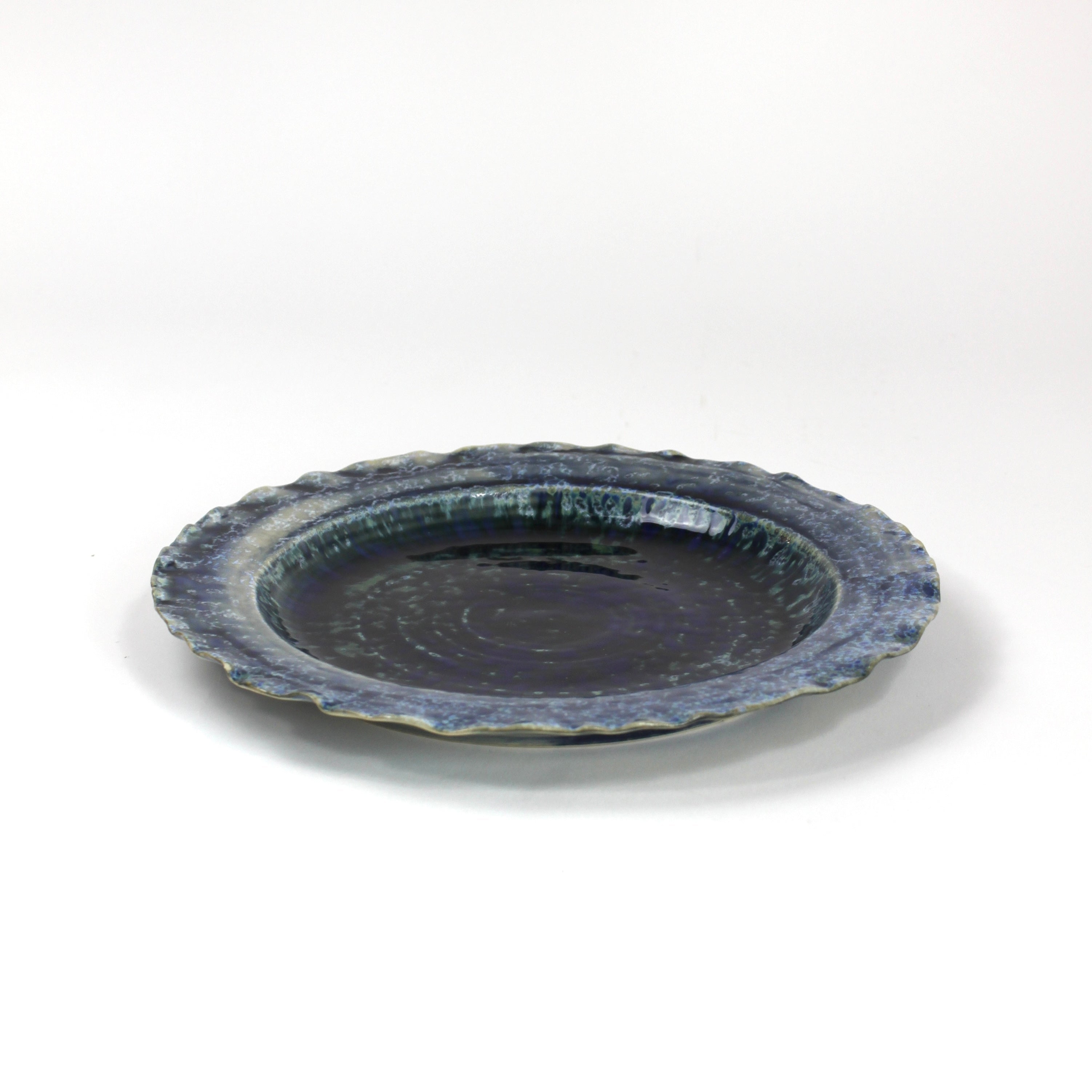 a glazed blue ceramic dinner plate from madcap cottage