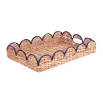 a rattan scalloped tray with navy blue trim