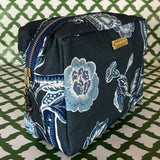 Front 3/4 view of Temple Garden toiletry bag in navy blue features light blue floral motif.