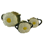 a vintage daisy creamer set featuring three ceramic creamer pieces with large daisies on the sides. 