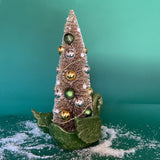 back of a green Vintage Ceramic Swan w/ Gold Christmas Tree Centerpiece against a green background. 
