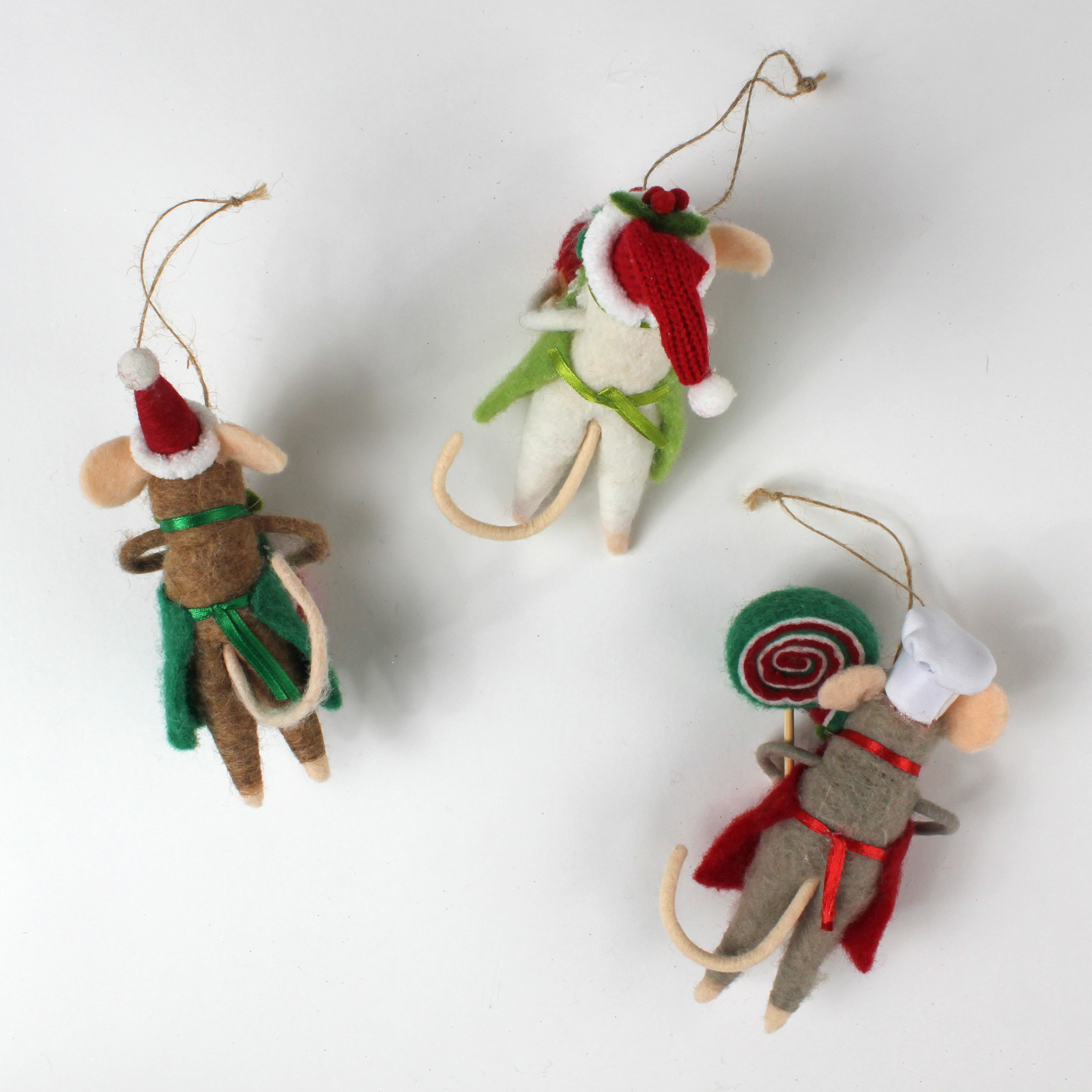 back of the three festive felt mouse ornaments wear holiday outfits—one holds a gingerbread cookie, another a giant lollipop, and the third a Christmas pudding