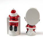 Two ceramic christmas salt and pepper shakers shaped like the letters 'H' and 'O' with Santa Claus figures on a white background.