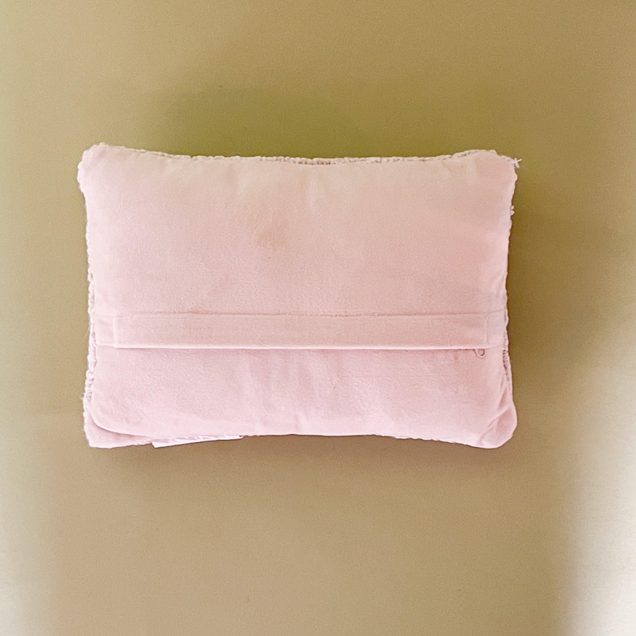 Back view of A purple easter pillow with two easter eggs with a yellow chick on top