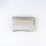 reverse back of a Rectangular green decorative pillow with a hooked texture, featuring a colorful pattern of golf tees in white, red, blue, yellow, and peach tones.