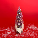 back of a White Vintage Arched-Neck Ceramic Swan w/Pink Glitter Christmas Tree Centerpiece against a red background. 