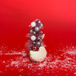 back of a Vintage Small White Ceramic Swan w/ Pink Glitter Christmas Tree Centerpiece against a red background. 