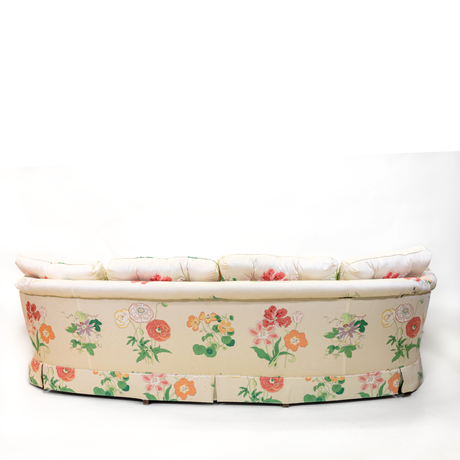 The back of a curved pastel vintage floral sofa