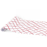 A white paper table runner with intersecting pink and red crosshatch lines in a modern geometric pattern.