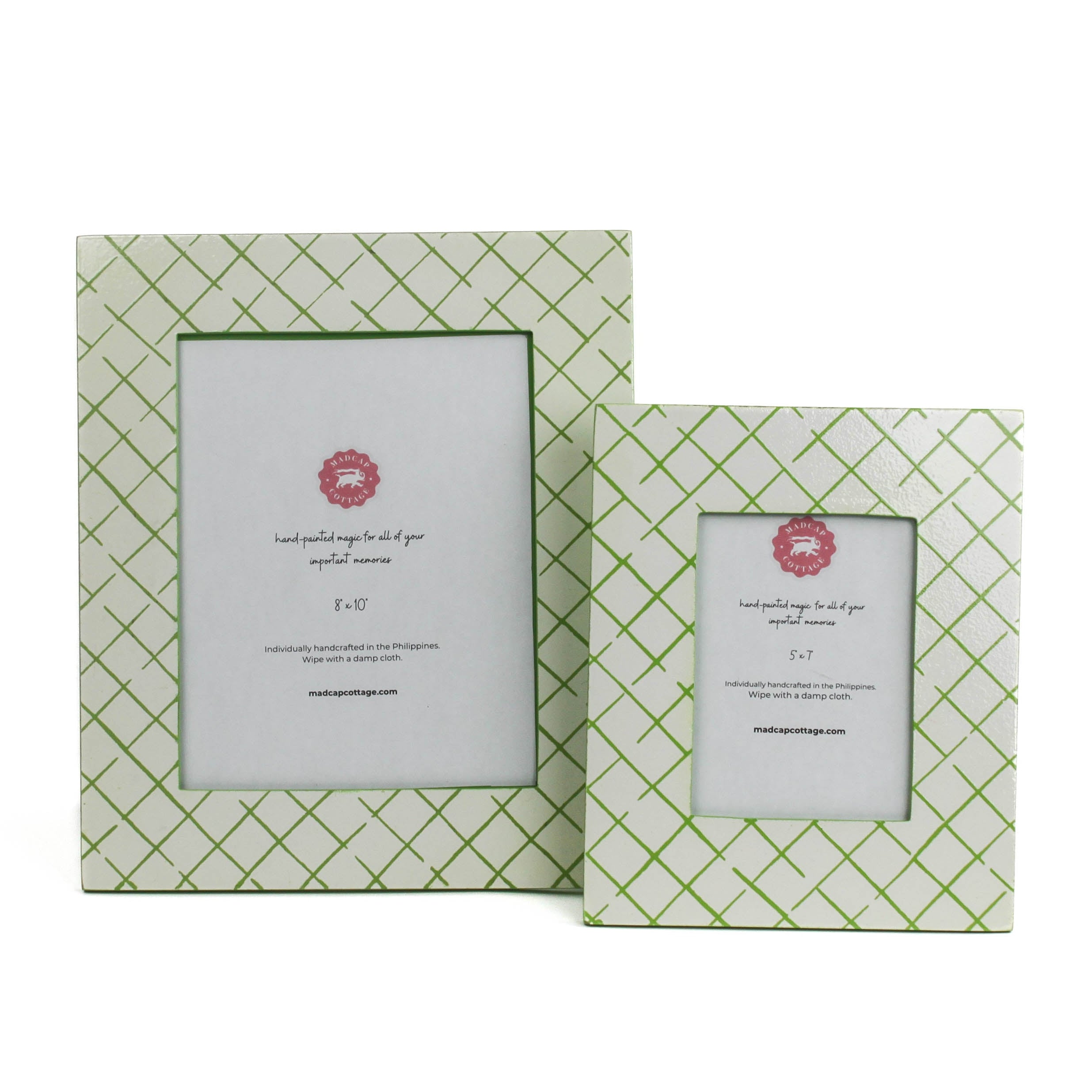 Two Bahama Court white and green hand painted photo frames on a white background