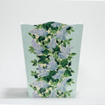 a blue floral wastepaper basket with a central repeating hydrangea pattern on each side. 