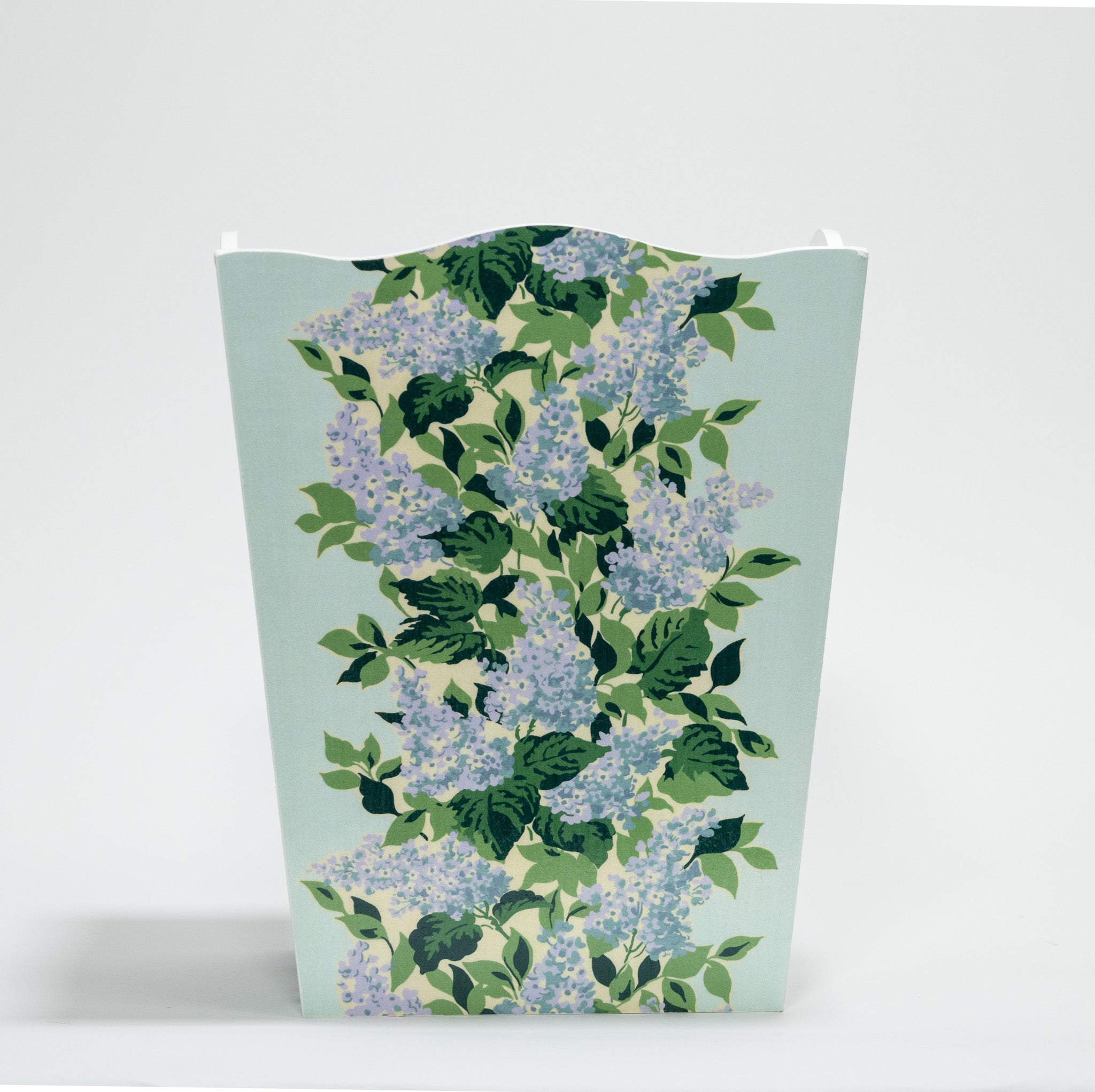 a blue floral wastepaper basket with a central repeating hydrangea pattern on each side. 