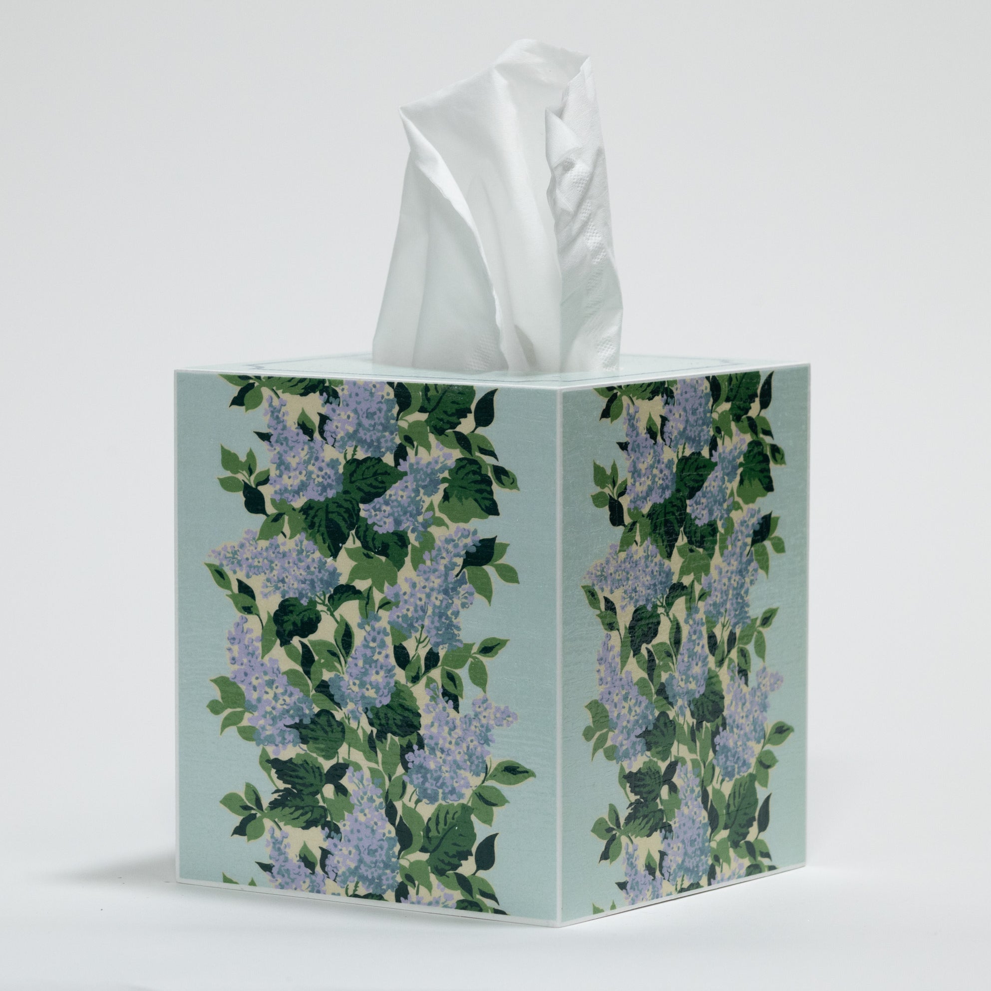 a blue floral tissue box cover with a repeating hydrangea pattern down the center of each side. 