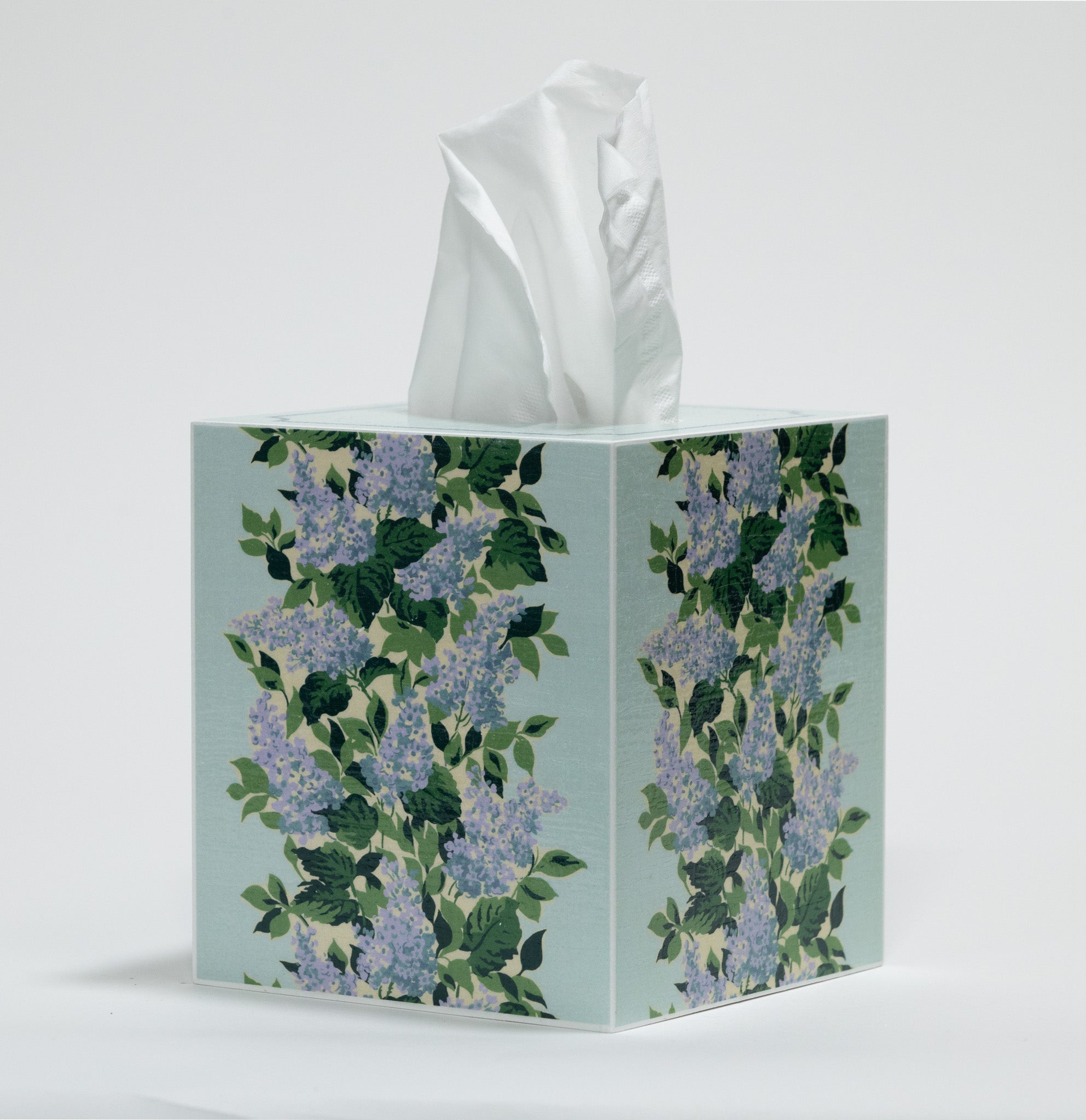 a blue floral tissue box cover with a repeating hydrangea pattern down the center of each side. 