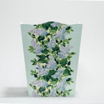 a blue floral wastepaper basket with a central repeating hydrangea pattern on each side. 