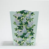a blue floral wastepaper basket with a central repeating hydrangea pattern on each side. 